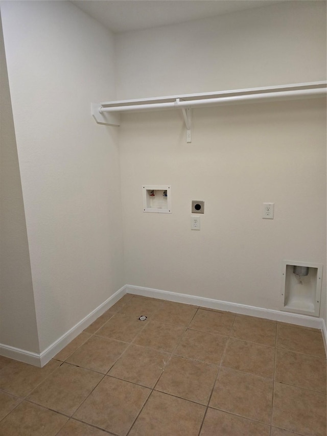 washroom featuring washer hookup, electric dryer hookup, laundry area, light tile patterned floors, and baseboards