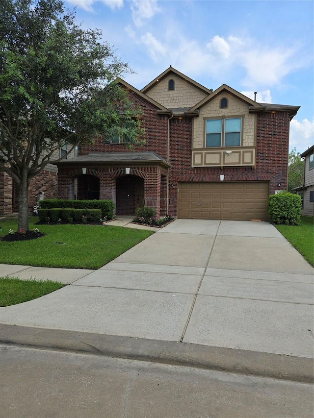 view of front of home featuring driveway, brick siding, a garage, and a front yard