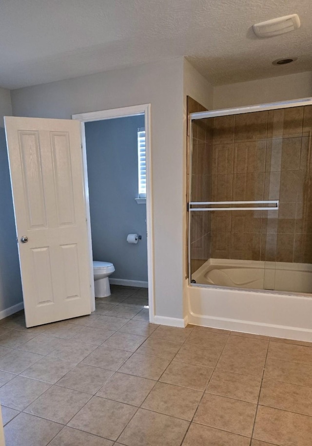 bathroom with toilet, enclosed tub / shower combo, a textured ceiling, baseboards, and tile patterned floors