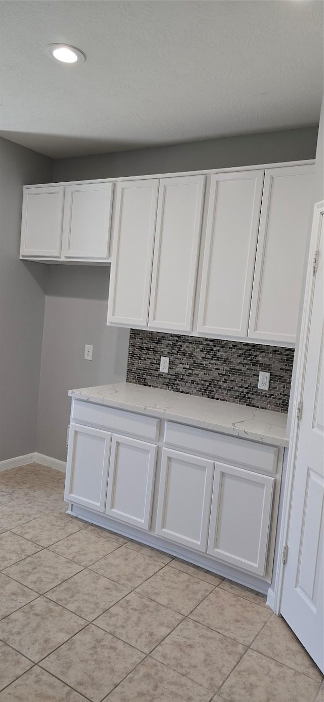 kitchen with white cabinetry and tasteful backsplash