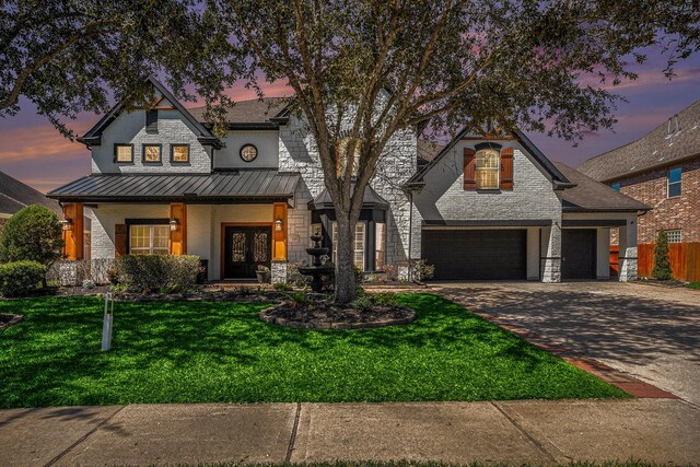 3318 King George Ln, Friendswood, TX 77546 - view of front of house featuring a front yard, a standing seam roof, concrete driveway, stone siding, and metal roof