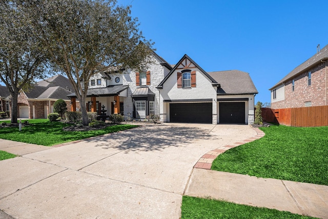 view of front of home featuring stone siding, driveway, a front yard, and fence