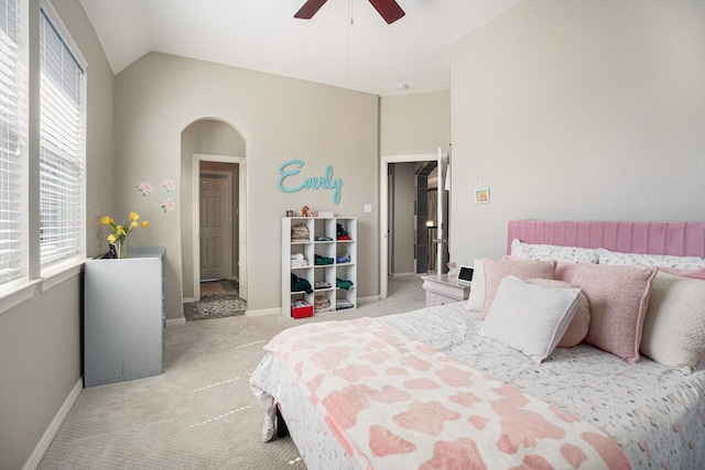 bedroom with baseboards, carpet floors, arched walkways, high vaulted ceiling, and a ceiling fan