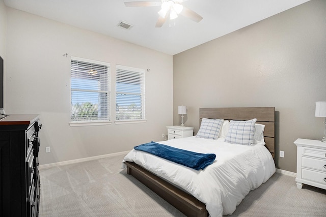 bedroom featuring visible vents, light carpet, baseboards, and a ceiling fan