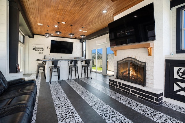 living room featuring recessed lighting, wood ceiling, and a lit fireplace