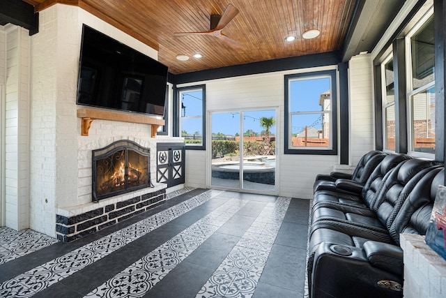 living area with a ceiling fan, wooden ceiling, recessed lighting, and a fireplace