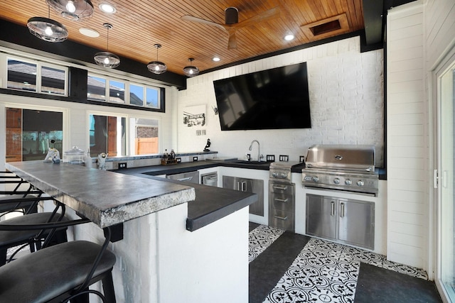 view of patio with ceiling fan, exterior kitchen, outdoor wet bar, a grill, and a sink