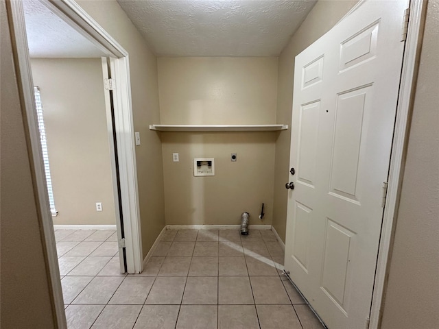 clothes washing area featuring light tile patterned floors, laundry area, hookup for an electric dryer, and gas dryer hookup