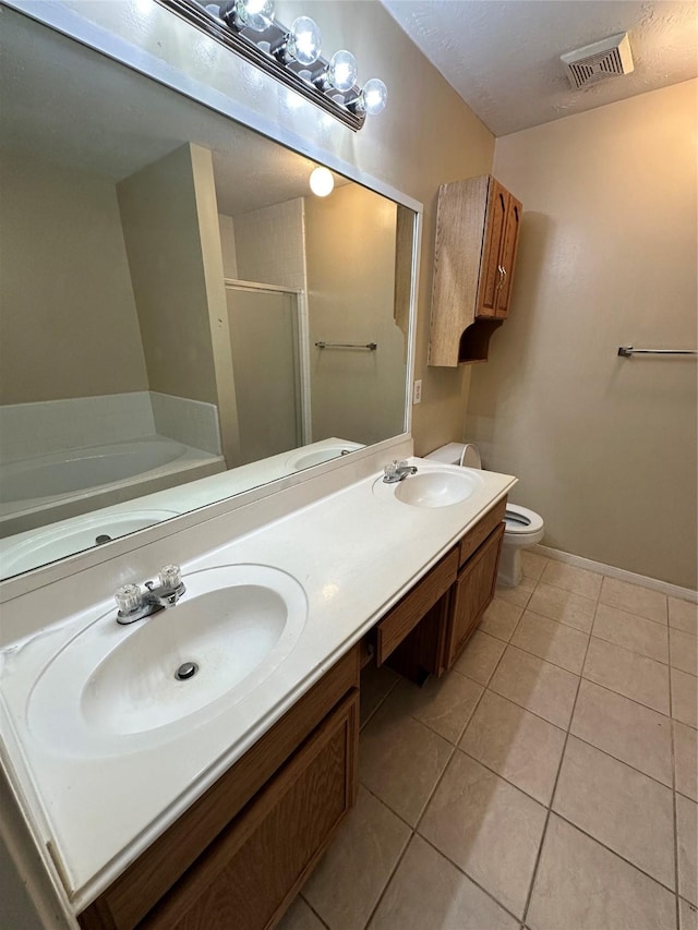 bathroom with a sink, visible vents, a stall shower, and tile patterned floors