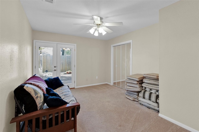 sitting room with ceiling fan, visible vents, baseboards, french doors, and carpet