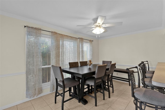 dining space featuring ornamental molding, light tile patterned flooring, and ceiling fan