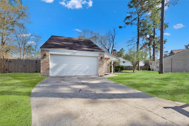 exterior space featuring a garage, concrete driveway, a lawn, and fence