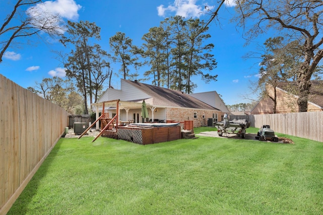 view of yard with a fenced backyard, a patio, a hot tub, and central air condition unit