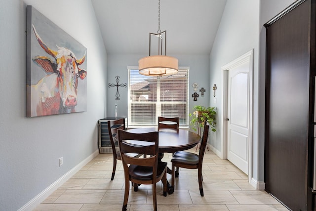 dining area with vaulted ceiling and baseboards