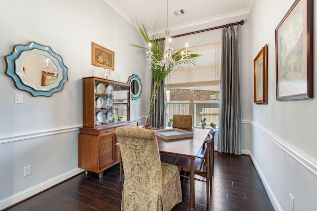 dining area featuring dark wood-type flooring, visible vents, crown molding, and an inviting chandelier