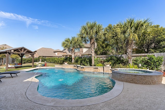 view of pool featuring a pool with connected hot tub, a patio area, fence, and a gazebo