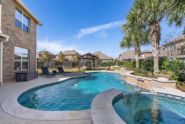 view of swimming pool featuring fence private yard, a pool with connected hot tub, a patio area, and a gazebo