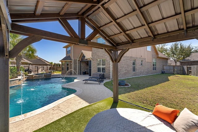 view of swimming pool featuring a yard, a patio area, a fenced backyard, and a pool with connected hot tub