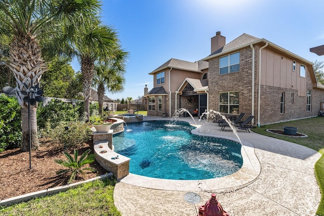 view of pool featuring a patio area, a fenced backyard, and a pool with connected hot tub