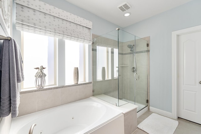 bathroom featuring a wealth of natural light, visible vents, a shower stall, and a whirlpool tub