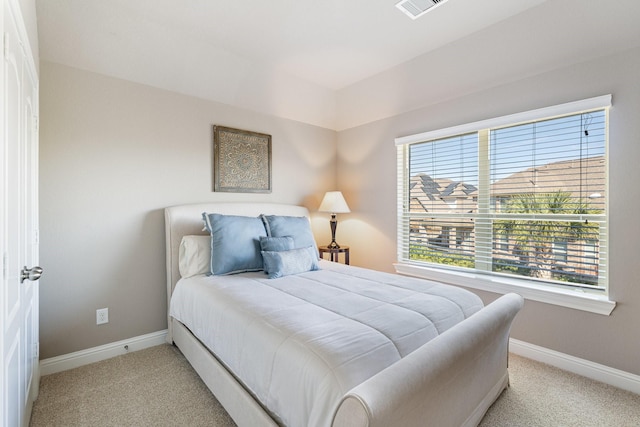 bedroom featuring light carpet, visible vents, and baseboards