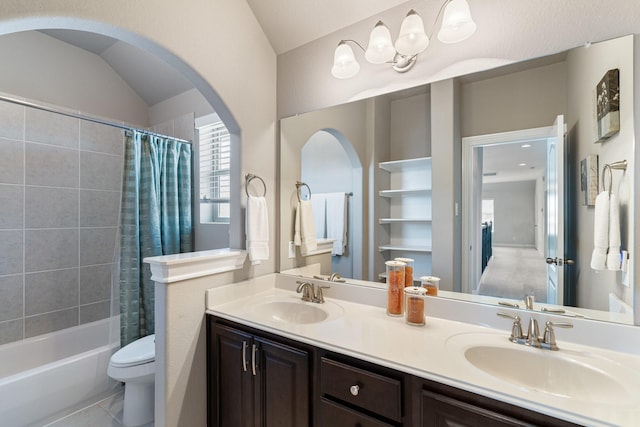 bathroom featuring shower / bath combination with curtain, a sink, toilet, and double vanity