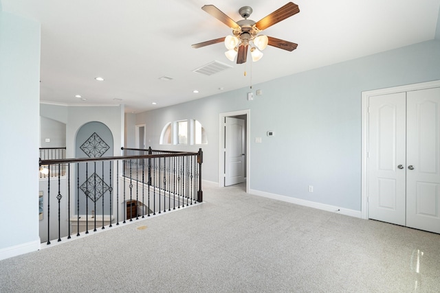 carpeted empty room featuring ceiling fan, recessed lighting, visible vents, and baseboards