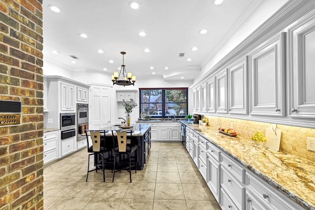 kitchen featuring decorative backsplash, light stone countertops, and crown molding