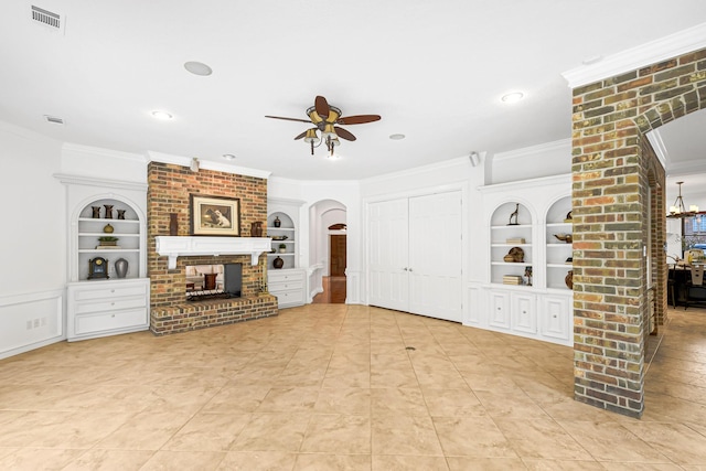 unfurnished living room featuring arched walkways, visible vents, a fireplace, and built in features