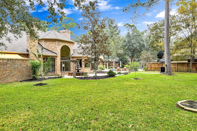 view of yard featuring a patio area, a pergola, and fence