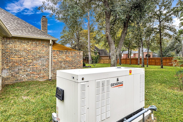 details featuring fence, a power unit, roof with shingles, brick siding, and a chimney