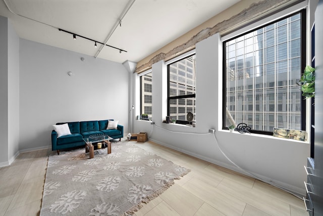 sitting room featuring baseboards and track lighting