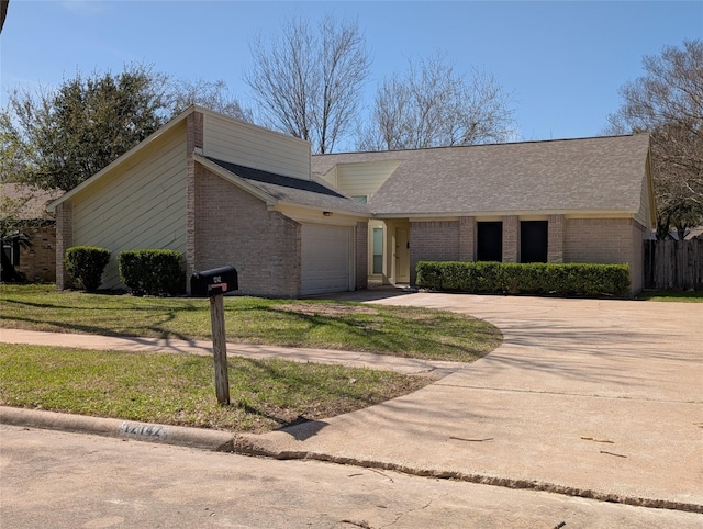 mid-century modern home with a garage, brick siding, concrete driveway, and a front lawn