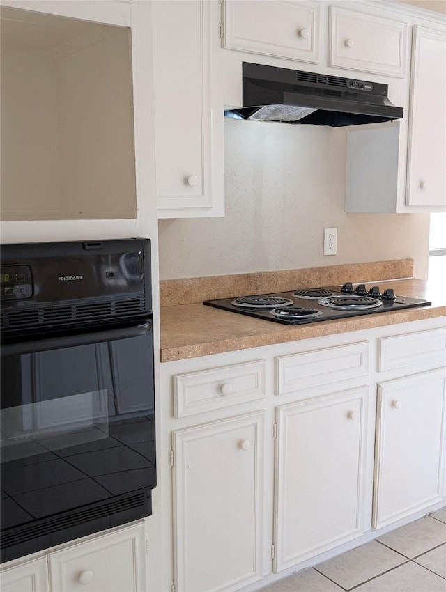 kitchen featuring black appliances, under cabinet range hood, white cabinetry, light tile patterned flooring, and light countertops