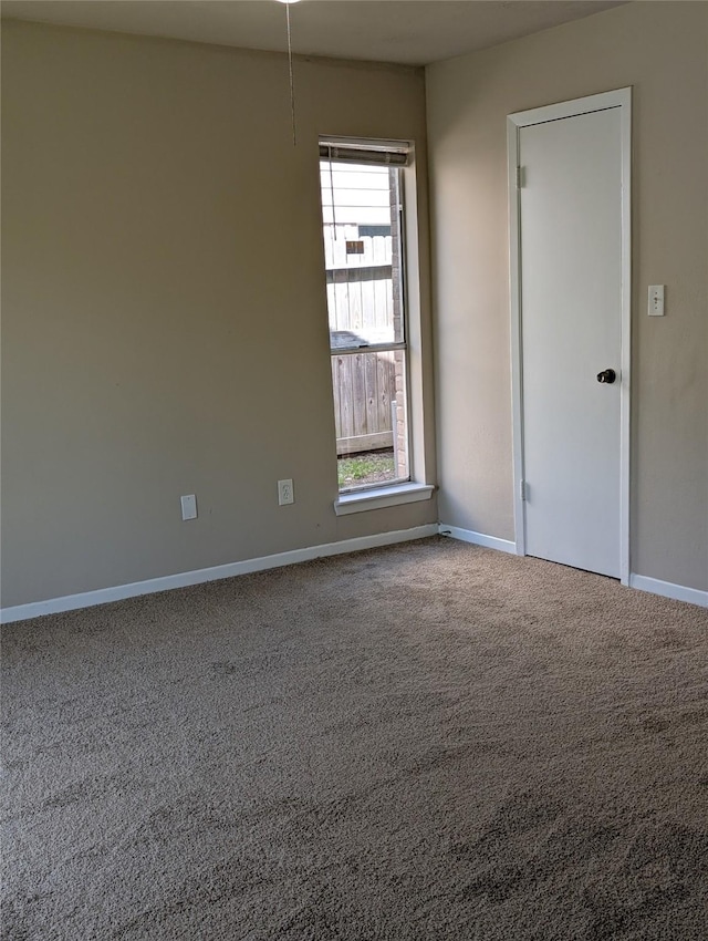 unfurnished room featuring baseboards and carpet flooring