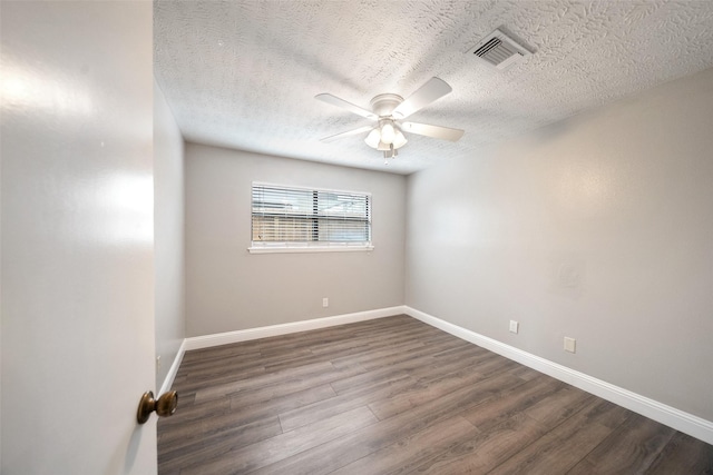 empty room featuring visible vents, baseboards, a textured ceiling, a ceiling fan, and dark wood-style flooring