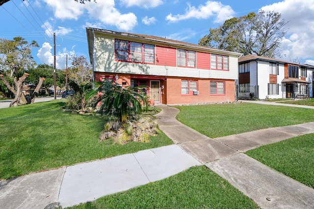 view of front facade featuring brick siding and a front lawn