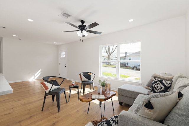 living area with recessed lighting, visible vents, baseboards, and light wood finished floors