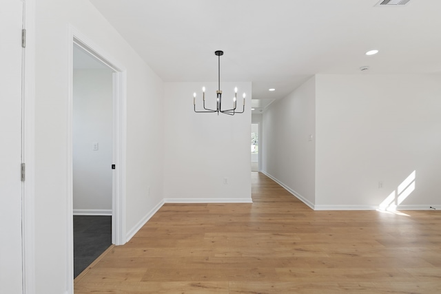 unfurnished dining area featuring recessed lighting, light wood-type flooring, and baseboards