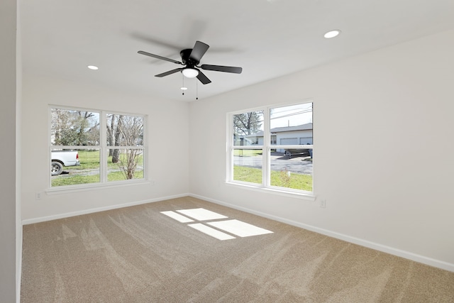 carpeted spare room with recessed lighting, baseboards, and a ceiling fan