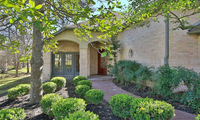 doorway to property with french doors and brick siding