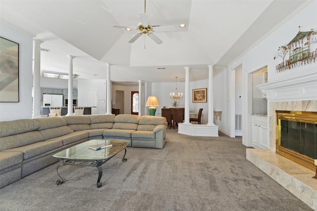 living area featuring ornate columns, a premium fireplace, high vaulted ceiling, carpet floors, and ceiling fan with notable chandelier