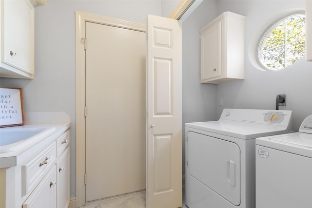 laundry area with a sink, cabinet space, separate washer and dryer, and marble finish floor