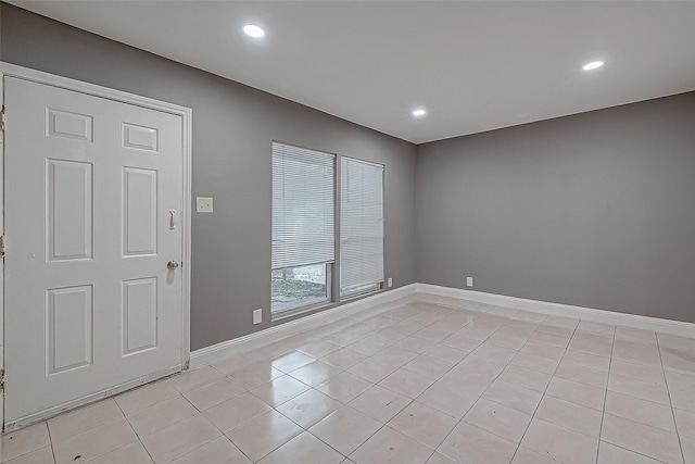 unfurnished room with light tile patterned floors, recessed lighting, and baseboards