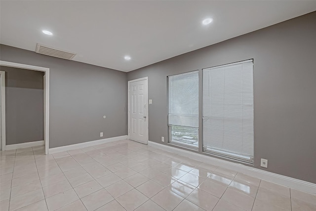 unfurnished room featuring recessed lighting, light tile patterned floors, baseboards, and visible vents