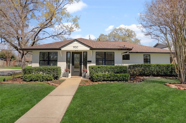 view of front of house featuring a front yard and stucco siding