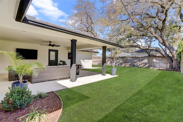 view of yard with a patio area, fence, and ceiling fan