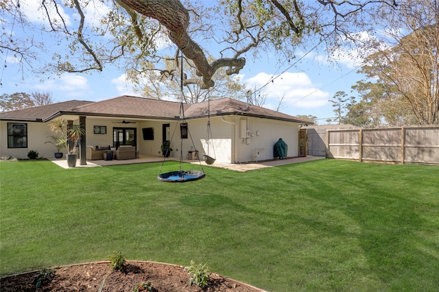 rear view of property with an outdoor living space, ceiling fan, fence, a yard, and a patio area