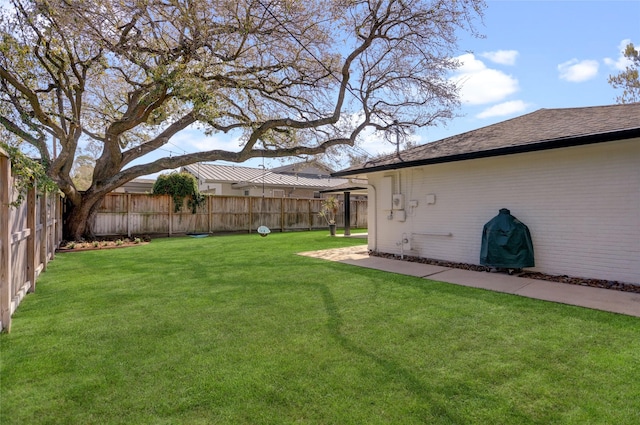 view of yard with a fenced backyard