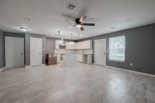 unfurnished living room with visible vents, recessed lighting, baseboards, and ceiling fan